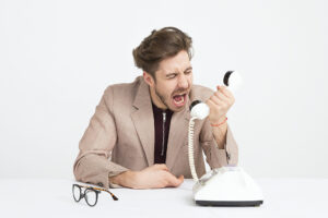 Man yelling in phone who hates his job